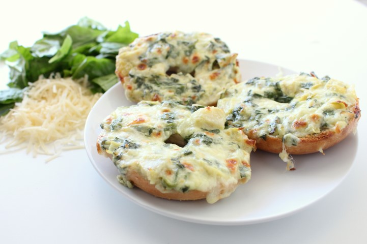 Spinach and Artichoke Dip baked on top of mini bagels. The classic dip gets a makeover in these cute little appetizers.