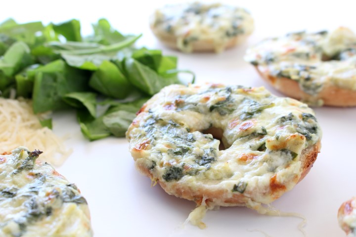 Spinach and Artichoke Dip baked on top of mini bagels. The classic dip gets a makeover in these cute little appetizers.