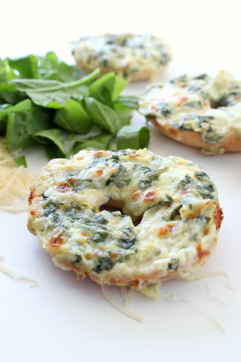 Spinach and Artichoke Dip baked on top of mini bagels. The classic dip gets a makeover in these cute little appetizers.