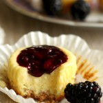 Cute mini blackberry cheesecakes made in a muffin tin with blackberry filling on top. Perfect sized portions of cheesecake to take with you for picnics, potlucks and parties. A fun summer dessert.