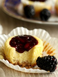 Cute mini blackberry cheesecakes made in a muffin tin with blackberry filling on top. Perfect sized portions of cheesecake to take with you for picnics, potlucks and parties. A fun summer dessert.
