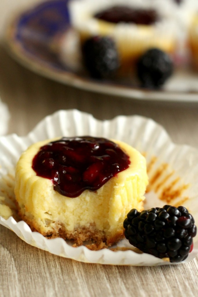 Cute mini blackberry cheesecakes made in a muffin tin with blackberry filling on top. Perfect sized portions of cheesecake to take with you for picnics, potlucks and parties. A fun summer dessert. 