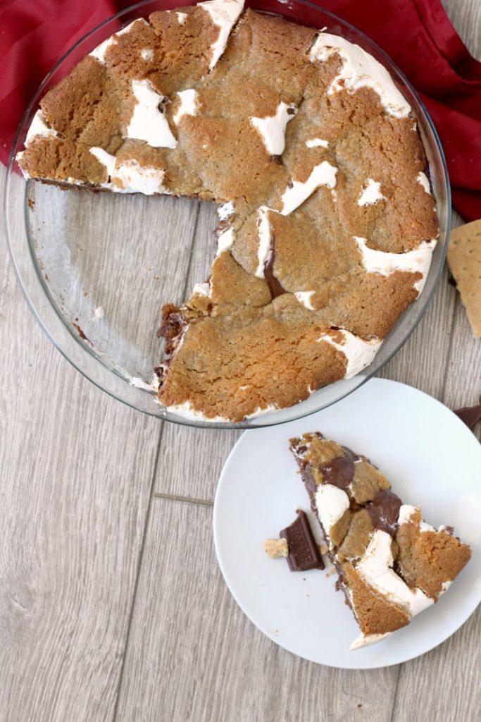 Nutella Smores Cookie Pie. An fun indulgent s'mores dessert. Everyone will love the warm graham cracker cookie, sticky marshmallow and rich hazelnut chocolate layer. Be sure to have friends around to help you eat it.