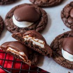 Chewy chocolate cookies topped with marshmallows and fudge frosting
