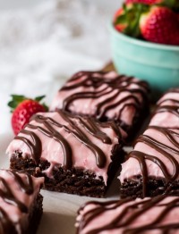 brownies with strawberry cream cheese frosting and a fudge drizzle