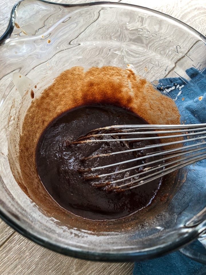 a whisk in brownie batter