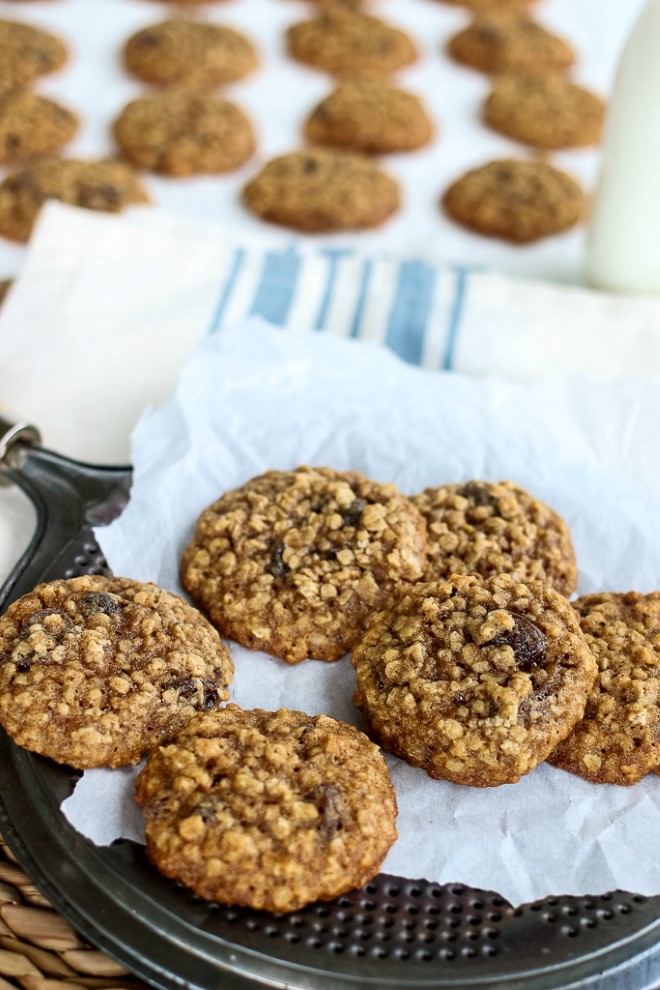 Oatmeal cookies recipe with raisins on parchment paper.