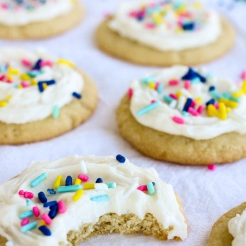 An iced sugar cookie with a bite out of it.