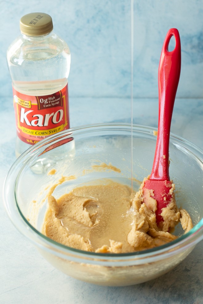 pouring corn syrup in the cookie dough
