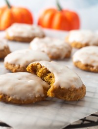 iced pumpkin oatmeal cookie with a bite out
