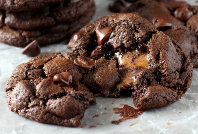 caramel stuffed chocolate cookies on parchment