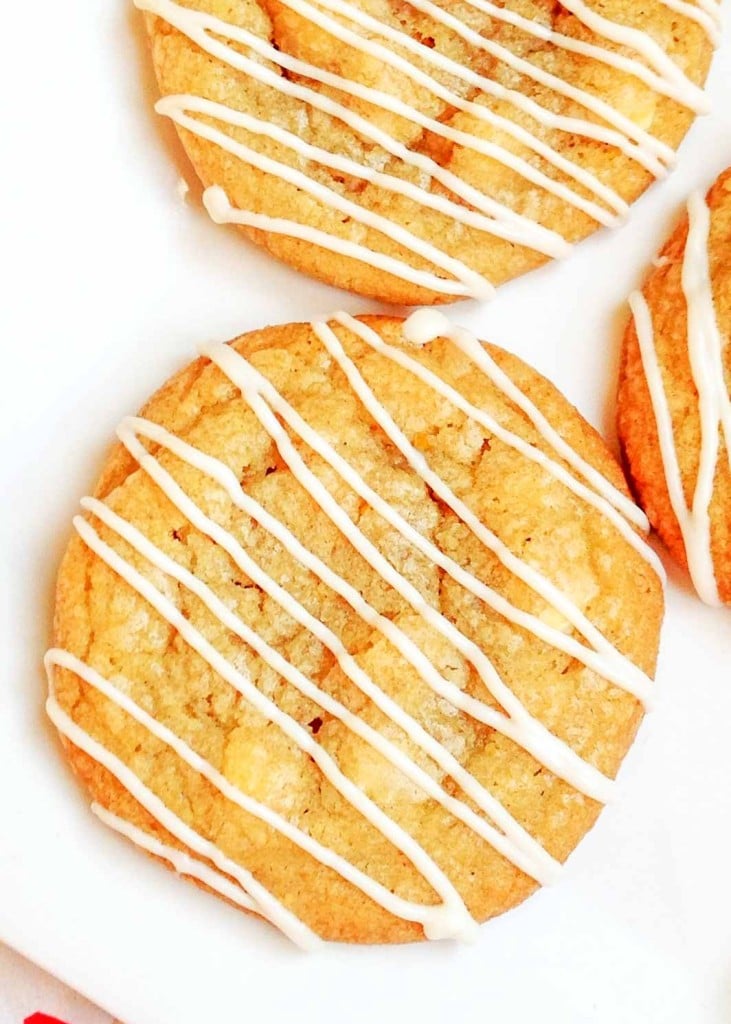 cookies with white icing are visible on a white plate in this vertically aligned photo