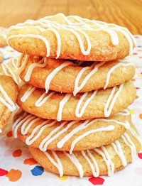 A close-up photo of five lemon cookies with white chocolate chips that have been stacked vertically