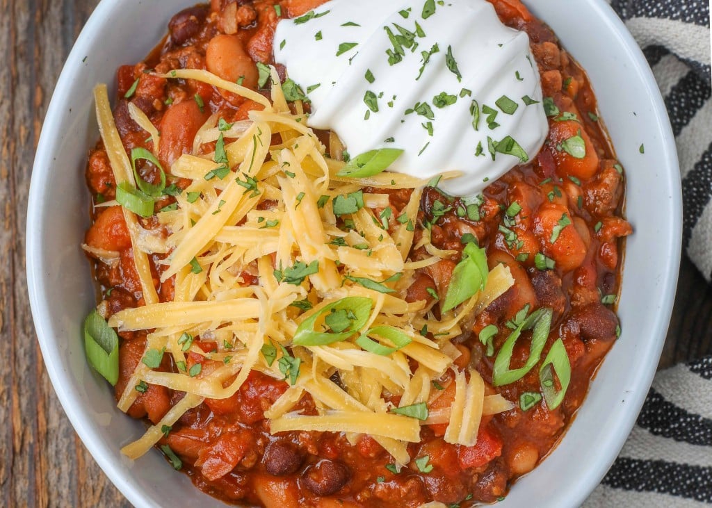 chili in white bowl with cheese on top