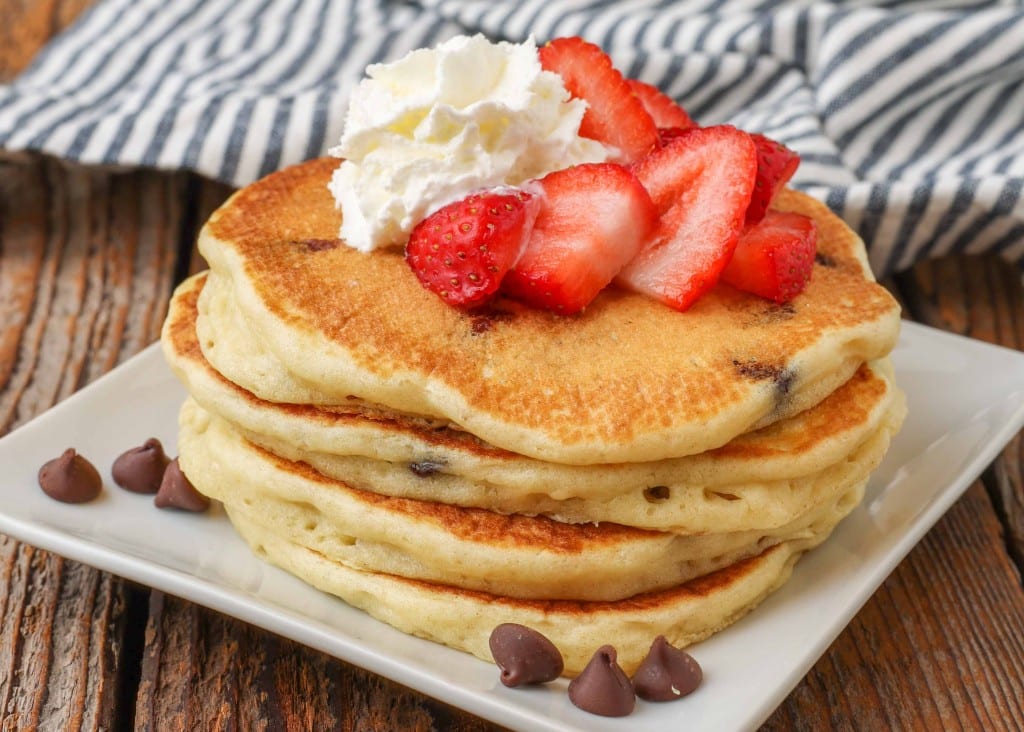 Chocolate Chip Pancakes on square white plate with strawberries