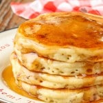 Sausage Pancakes with syrup stacked on plate