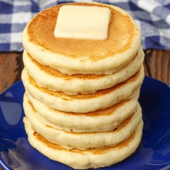 Silver Dollar Pancakes stacked on plate with pat of butter