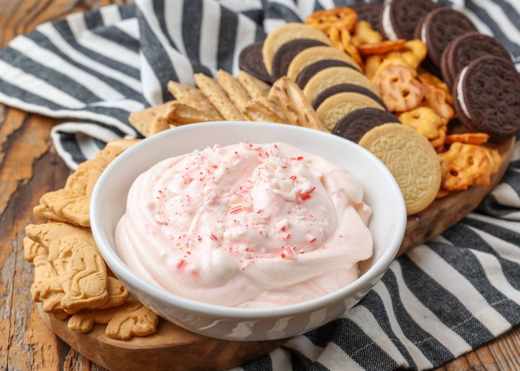 Candy Cane Dip with cookies, crackers, pretzels on striped towel