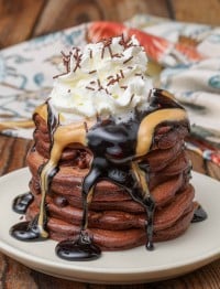 Chocolate pancakes with peanut butter and chocolate sauce and whipped cream on top