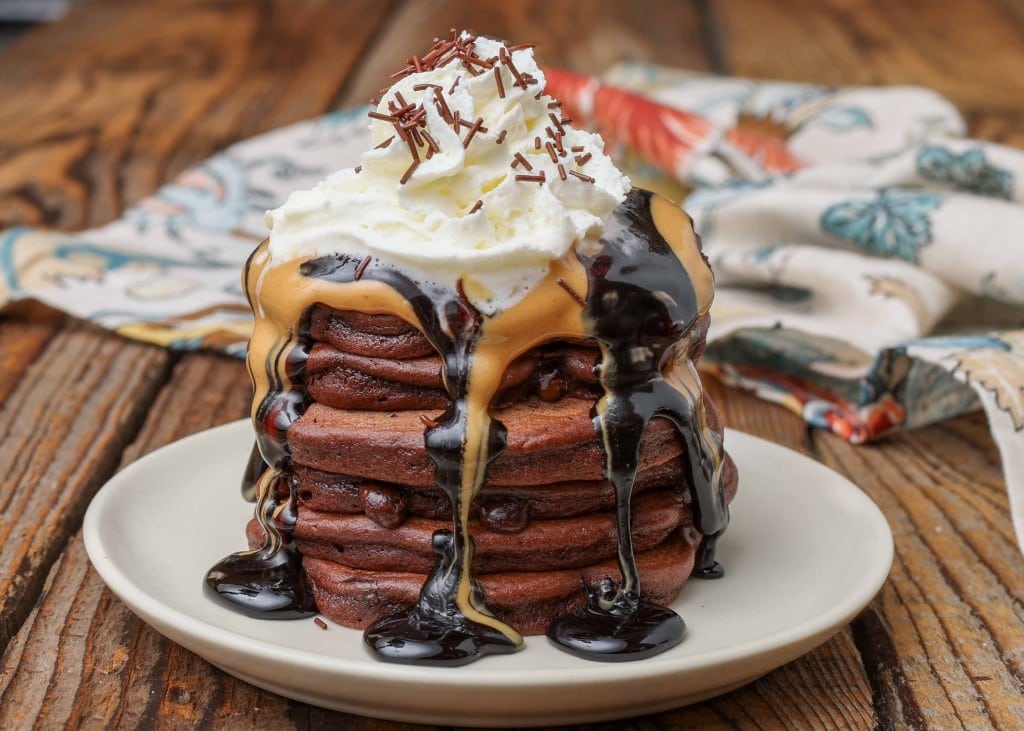 Chocolate pancakes with peanut butter, chocolate sauce, and whipped cream