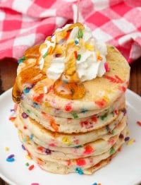 Funfetti Pancakes with whipped cream and syrup