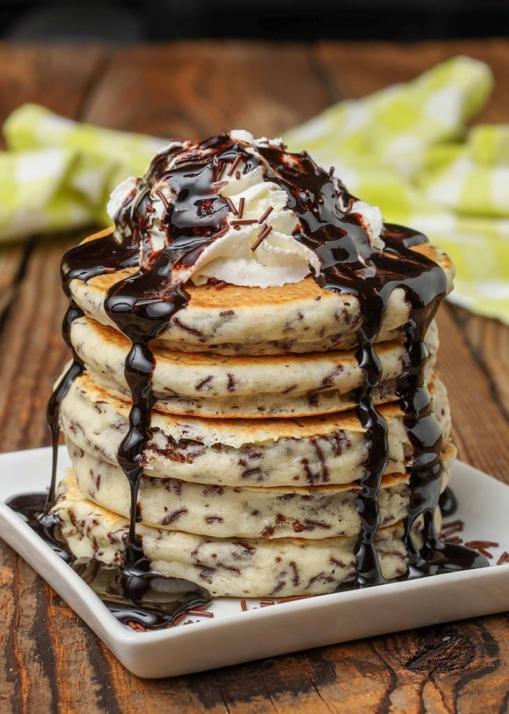 Chocolate Funfetti Pancakes with whipped cream and syrup