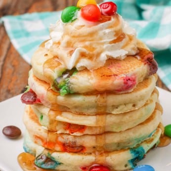 M&M Pancakes with whipped cream and syrup