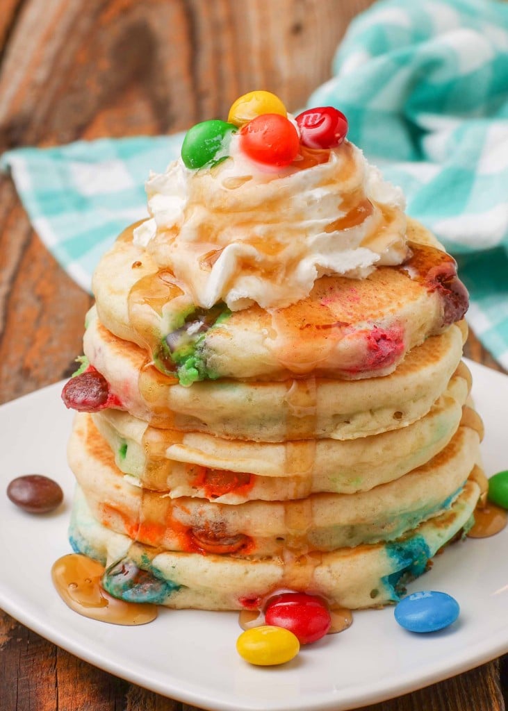 M&M Pancakes with whipped cream and syrup