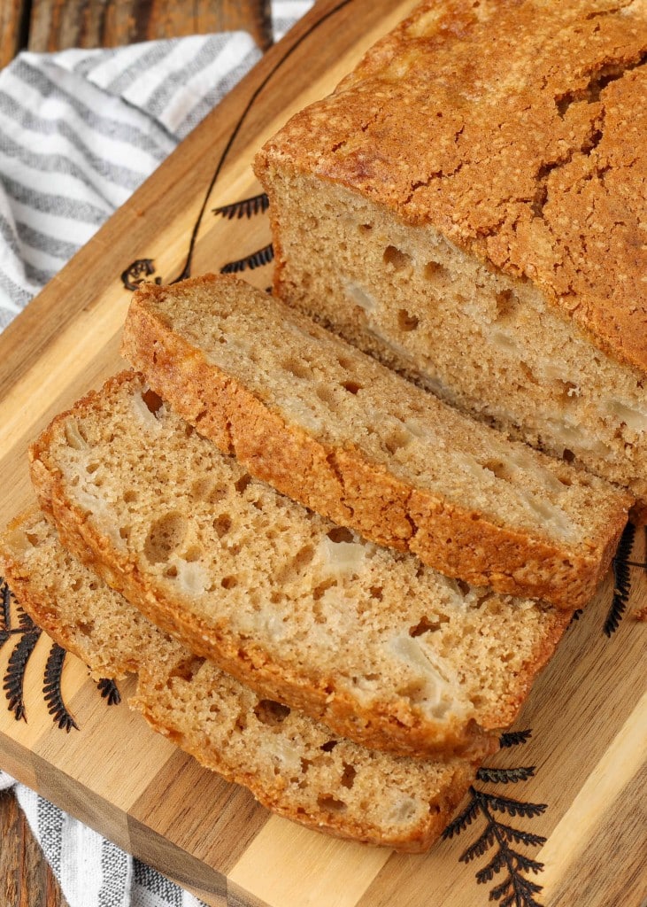 sliced bread on cutting board with striped towel