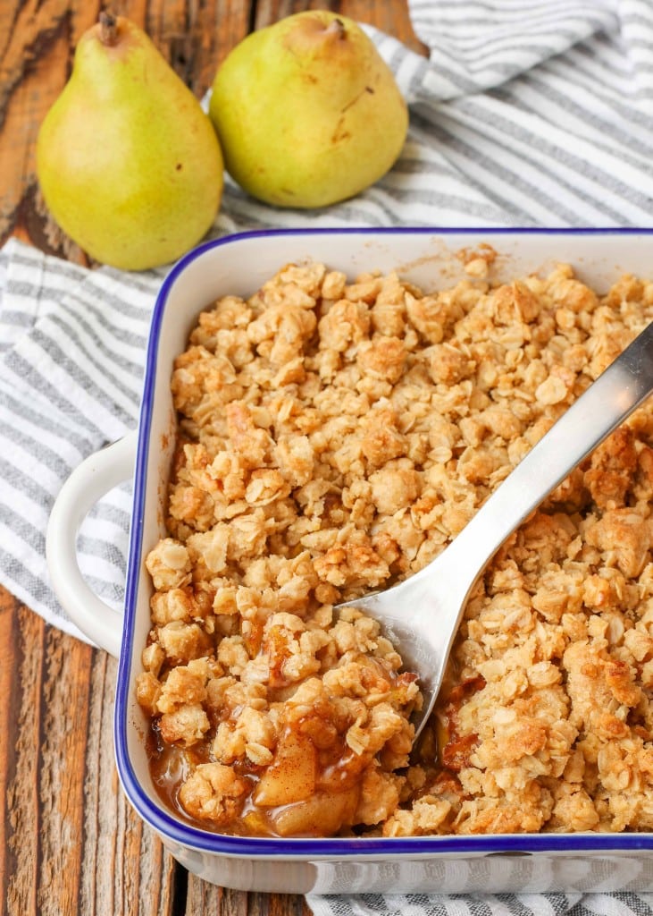 pear crisp in baking dish with serving spoon