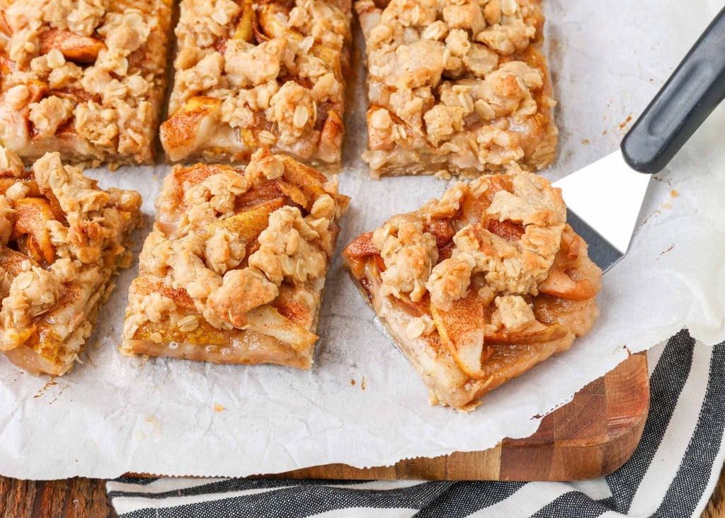 Pear Oatmeal Bars on parchment with server