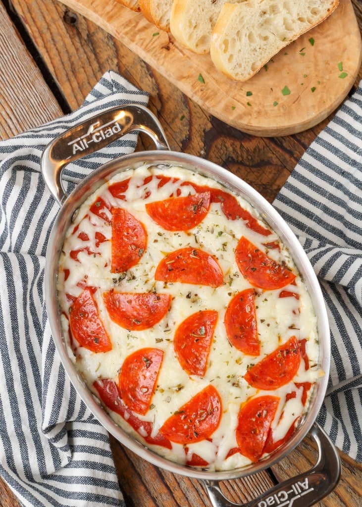 Pepperoni Pizza Dip in oval pan with black and white towel