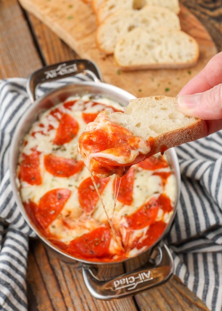 Pepperoni Pizza Dip with crostini and black and white towel