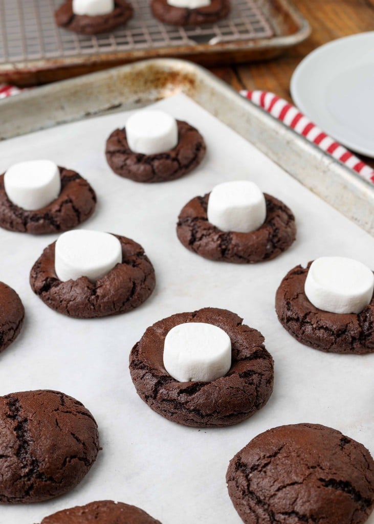 Chocolate Covered Marshmallow Cookies baked with half marshmallow on baking sheet