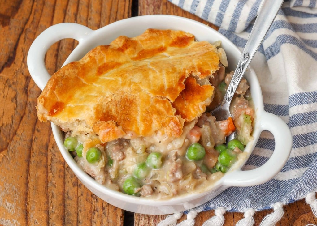 Ground Beef Pot Pie in white bowl with blue and white linen on table
