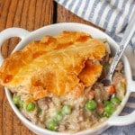 Ground Beef Pot Pie one slice in white dish with spoon
