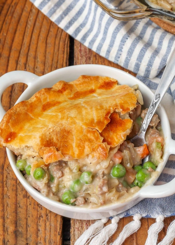 Ground Beef Pot Pie one slice in white dish with spoon