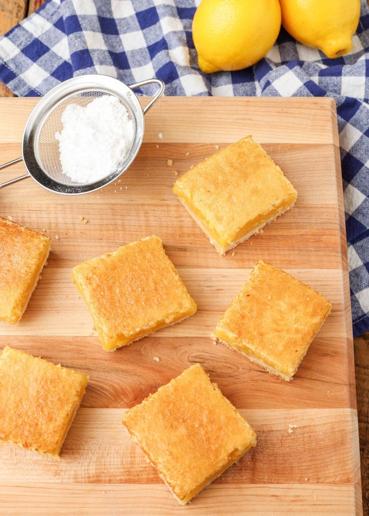 sliced lemon bars on cutting board before sprinkling with powdered sugar