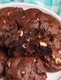 a close up shot of a halved chocolate cookie with white and dark chocolate morsels visible within
