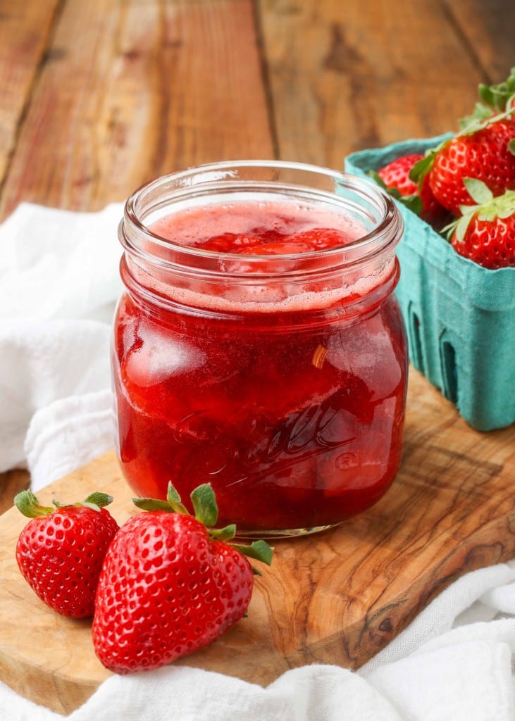 Strawberry Compote in glass jar with fresh berries