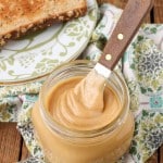 peanut butter mixture in jar with knife next to toast