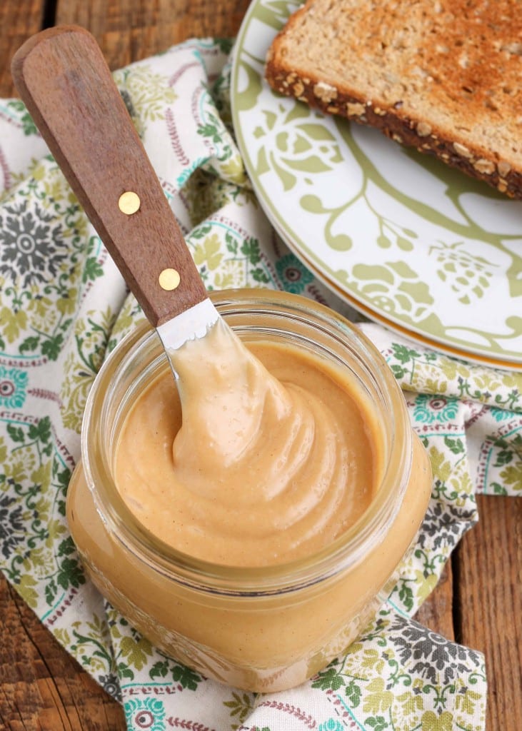 peanut butter spread in jar with knife 
