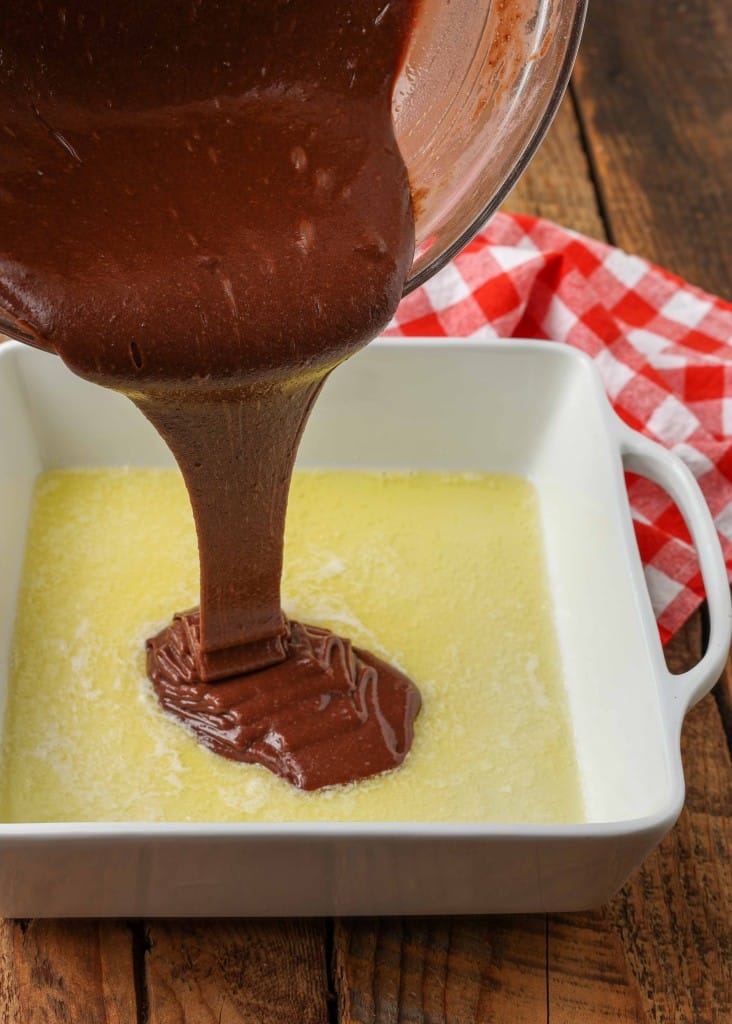 pour shot of chocolate batter into melted butter 