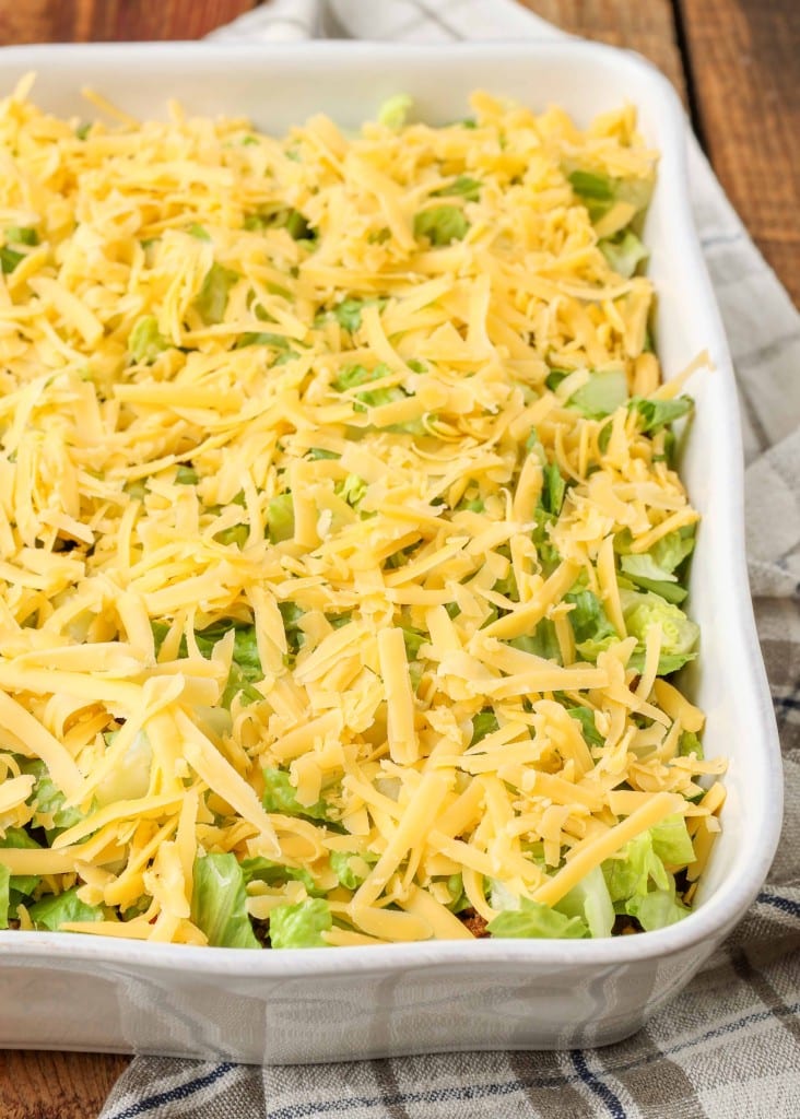 lettuce and cheese layers over ground beef taco dip