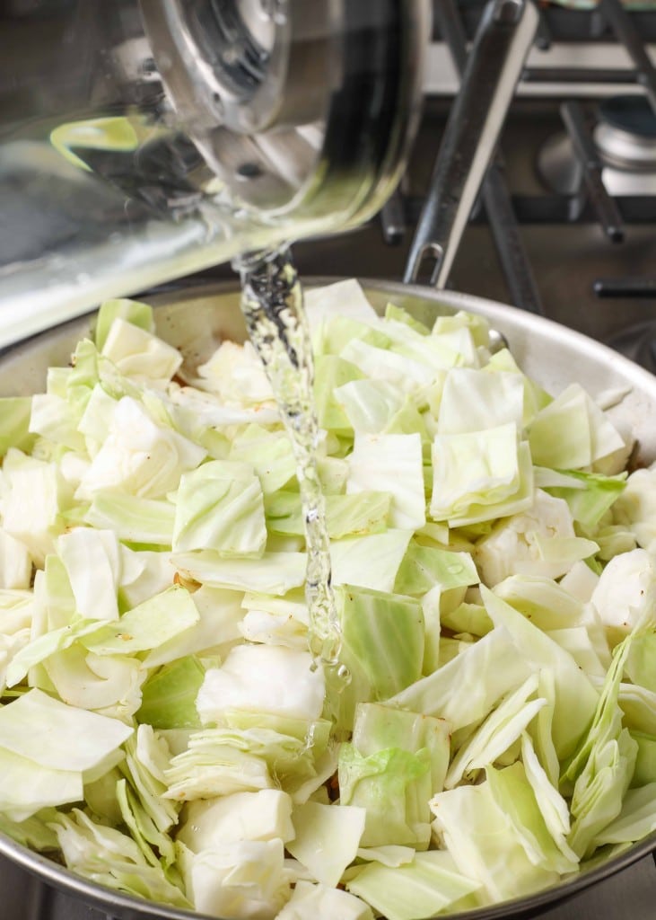 Lettuce and garlic in a stainless steel skillet