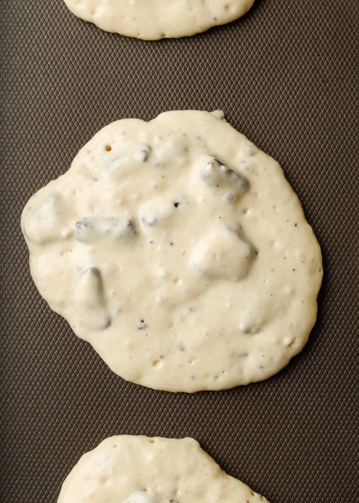 A process shot of oreo pancake batter having been placed on the griddle