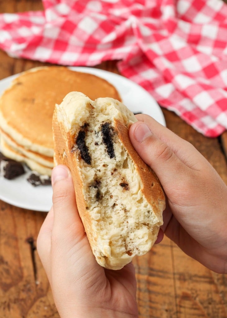 A closeup shot of the fluffy crumb of an oreo pancake with bits of cookies visible within