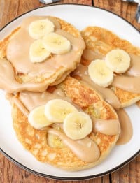 pancakes with peanut butter sauce and sliced bananas