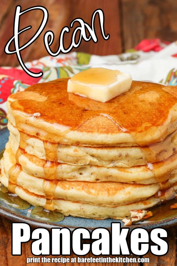 white lettering has been overlaid this image of a stack of pecan pancakes on a light blue ceramic plate. it reads, "Pecan Pancakes".