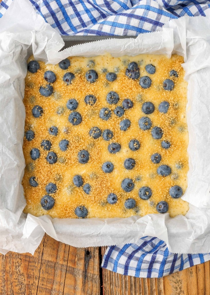 The blueberry buttermilk cake has been sprinkled with raw sugar and is ready to go into the oven to bake.